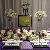 Bertram Inn Bridal Show 2011 - Main table display - Long and low centerpiece with hydrangea, stock roses, lissianthus and Baby's breath in high candle holders