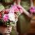 Bridesmaids bouquets of pink roses, pink dahlias, red dahlias, and red hypericum berries