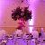 tall centerpiece lavender roses, purple lisianthus, greens, purple phaleanopsis orchids