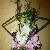 Modern bouquet of white dendrobium orchids, pink gladiolus blossoms, horsetail rush and fern fonds